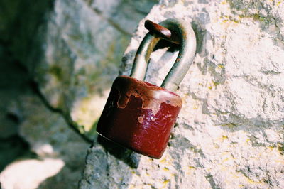 Close-up of padlock on stone wall