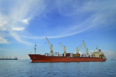 Ship moored at harbor against sky