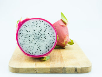 Close-up of fruit on table against white background