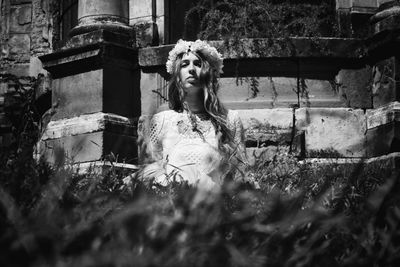 Woman in front of abandoned building