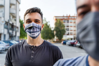 Portrait of young man standing on street