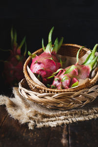 Dragon fruits in basket on table
