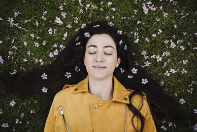 Portrait of smiling woman standing against plants