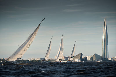 Boats in sea against sky