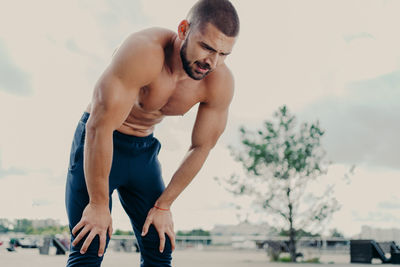 Shirtless man exercising outdoors