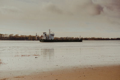 Ship sailing in sea against sky