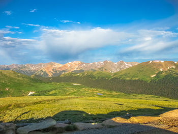 Scenic view of mountains against cloudy sky