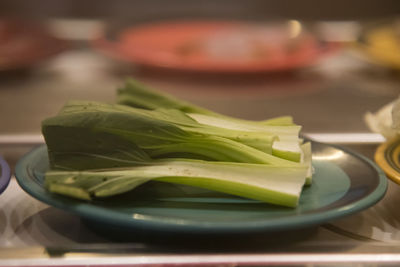 Close-up of green chili peppers in bowl on table