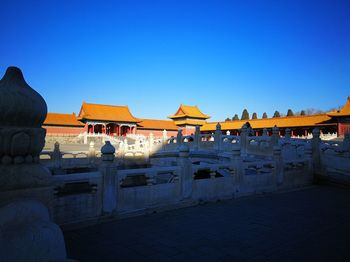 Statue of buildings against clear blue sky