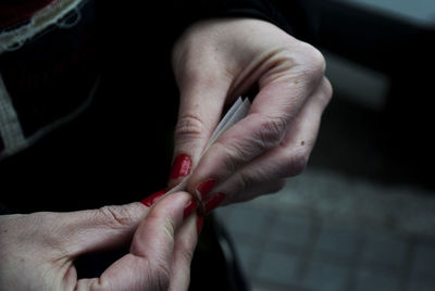 Close-up of woman hands holding tobacco product