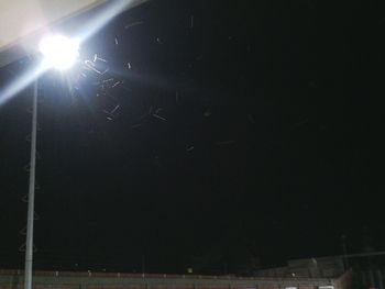 Low angle view of illuminated street light against sky
