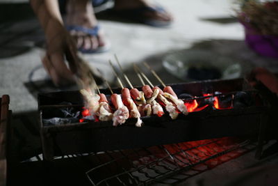 Close-up of preparing food on barbecue grill