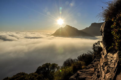 Scenic view of mountains against sky at sunset