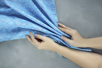 Woman hands with blue cleaner material