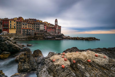 Scenic view of sea and buildings against sky