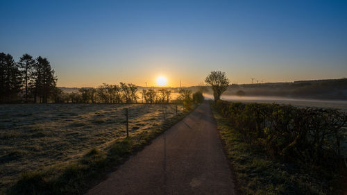 Scenic view of field against sky during sunset