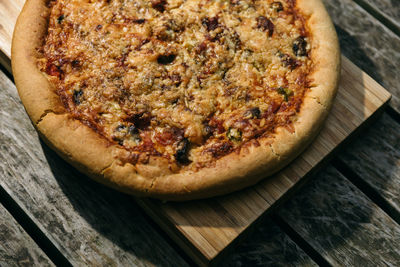 High angle view of pizza on cutting board