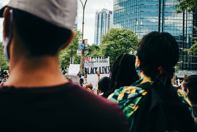 Rear view of people in city