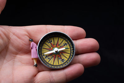 Close-up of hand holding navigational compass