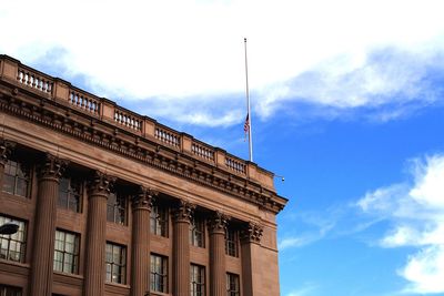 Low angle view of building against cloudy sky
