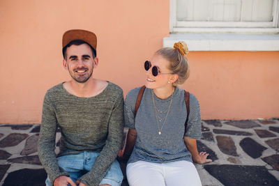 Young couple sitting outdoors