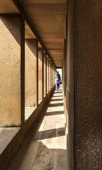 Woman walking in corridor of building