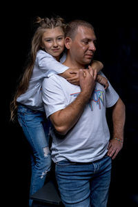 Rear view of couple against black background