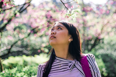 Portrait of beautiful young woman looking away
