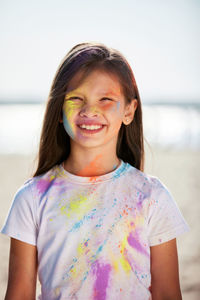 Portrait of smiling girl with powder paints on face