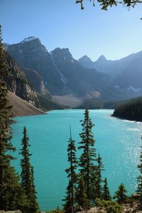 Scenic view of lake and mountains against blue sky