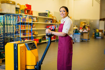 Portrait of smiling young woman standing on floor