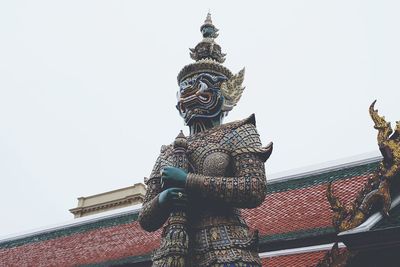 Low angle view of statue against building