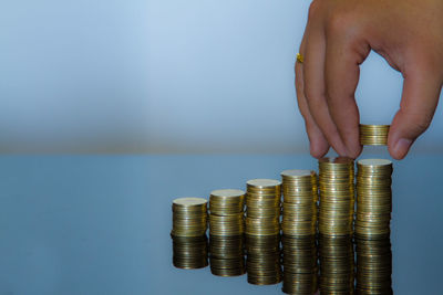 Cropped image of hand holding stack of coins