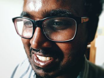 Close-up portrait of young man wearing sunglasses