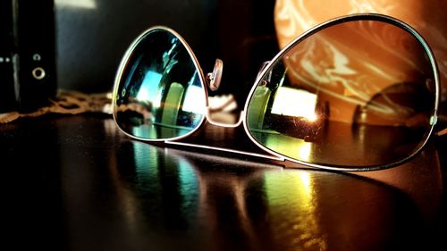 Close-up of sunglasses on glass table