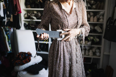 Midsection of woman standing at store