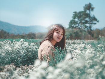 Portrait of beautiful woman on field