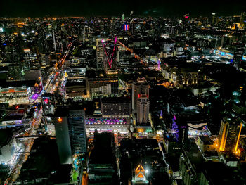 High angle view of illuminated buildings in city at night