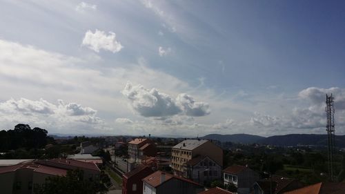 High angle view of houses against cloudy sky