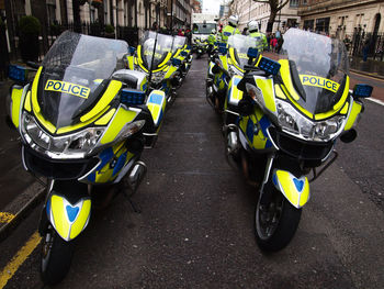 Police motorcycles parked on road in city