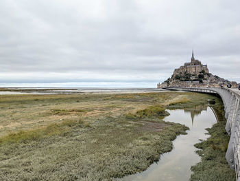 Scenic view of mont saint-michel island with sea and sky