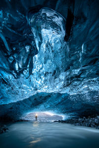 Man standing in frozen cave