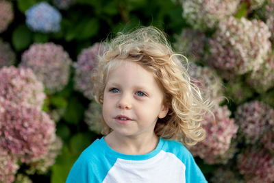 Cute girl against pink flowers