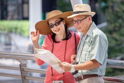 Young man with woman wearing hat