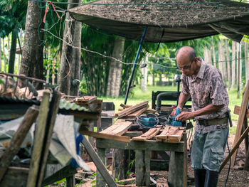 Senior man working in forest