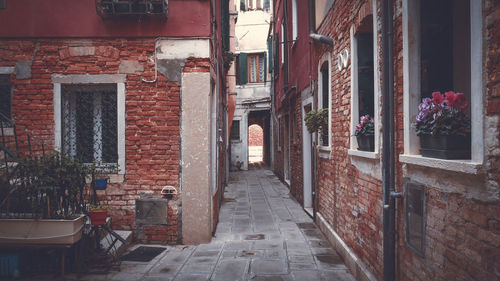 Footpath amidst buildings in city