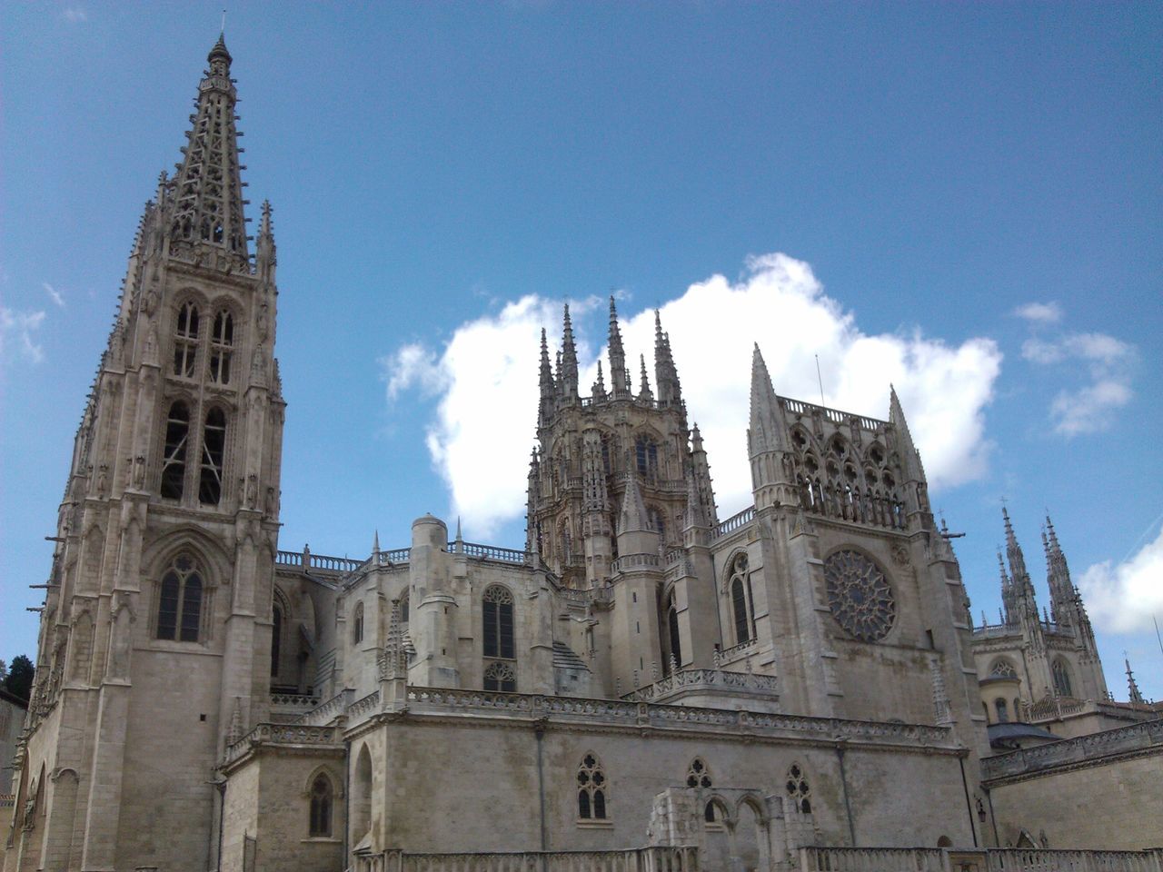 architecture, building exterior, religion, built structure, place of worship, church, low angle view, spirituality, cathedral, sky, famous place, travel destinations, history, blue, tourism, travel, cloud - sky, tower