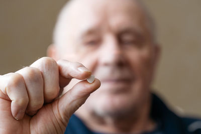 Close-up of man holding medicine