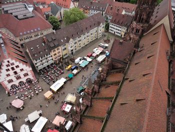 High angle view of people at market by freiburg minster in city