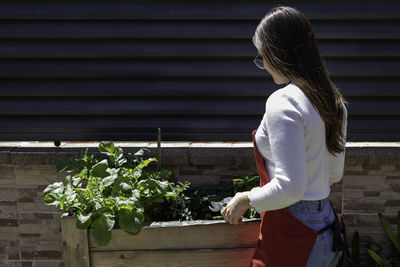 Young woman gardening at yard